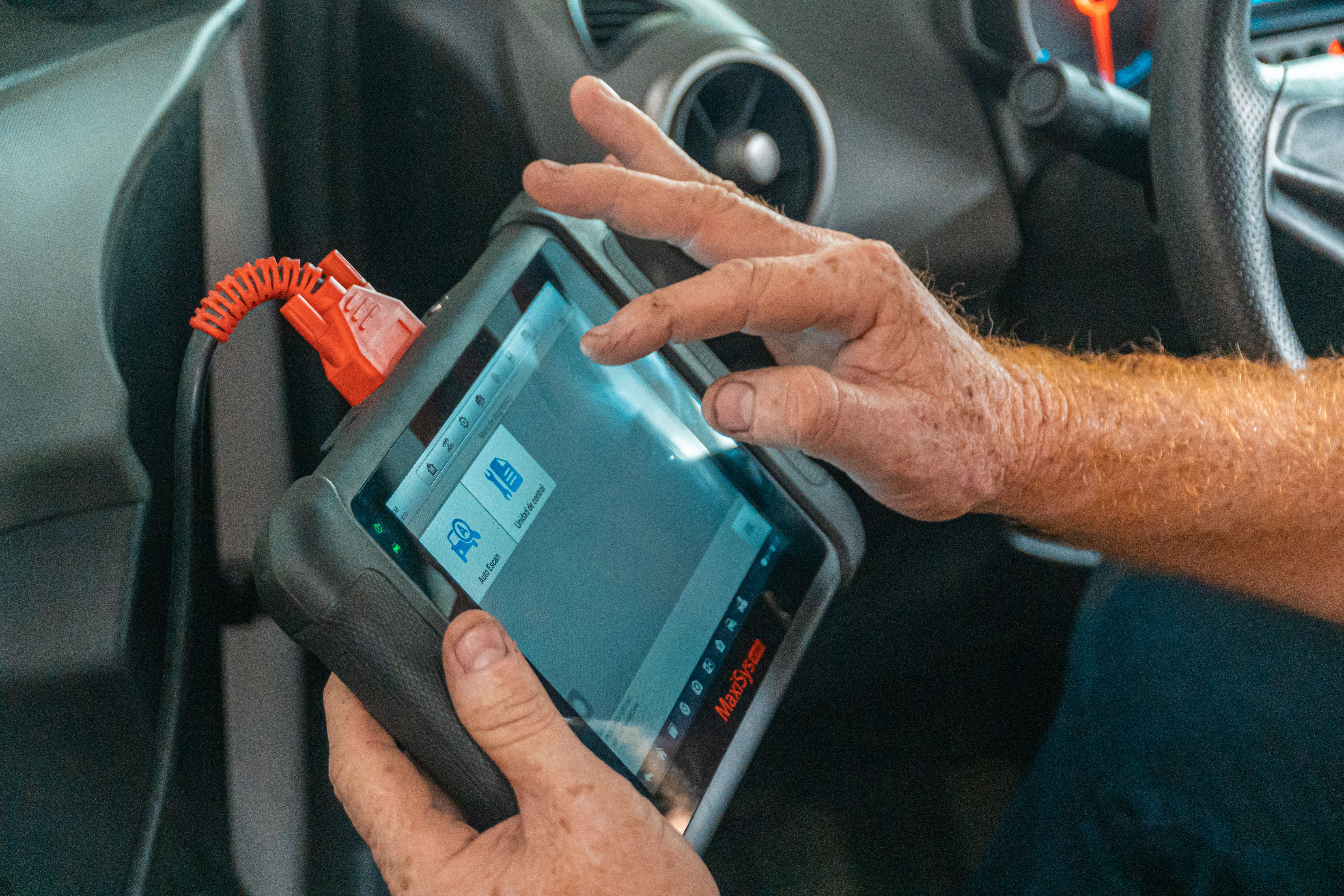 Technician performing vehicle diagnostics
